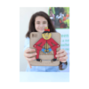 A girl showcasing her multiplication teacher toy after painting it