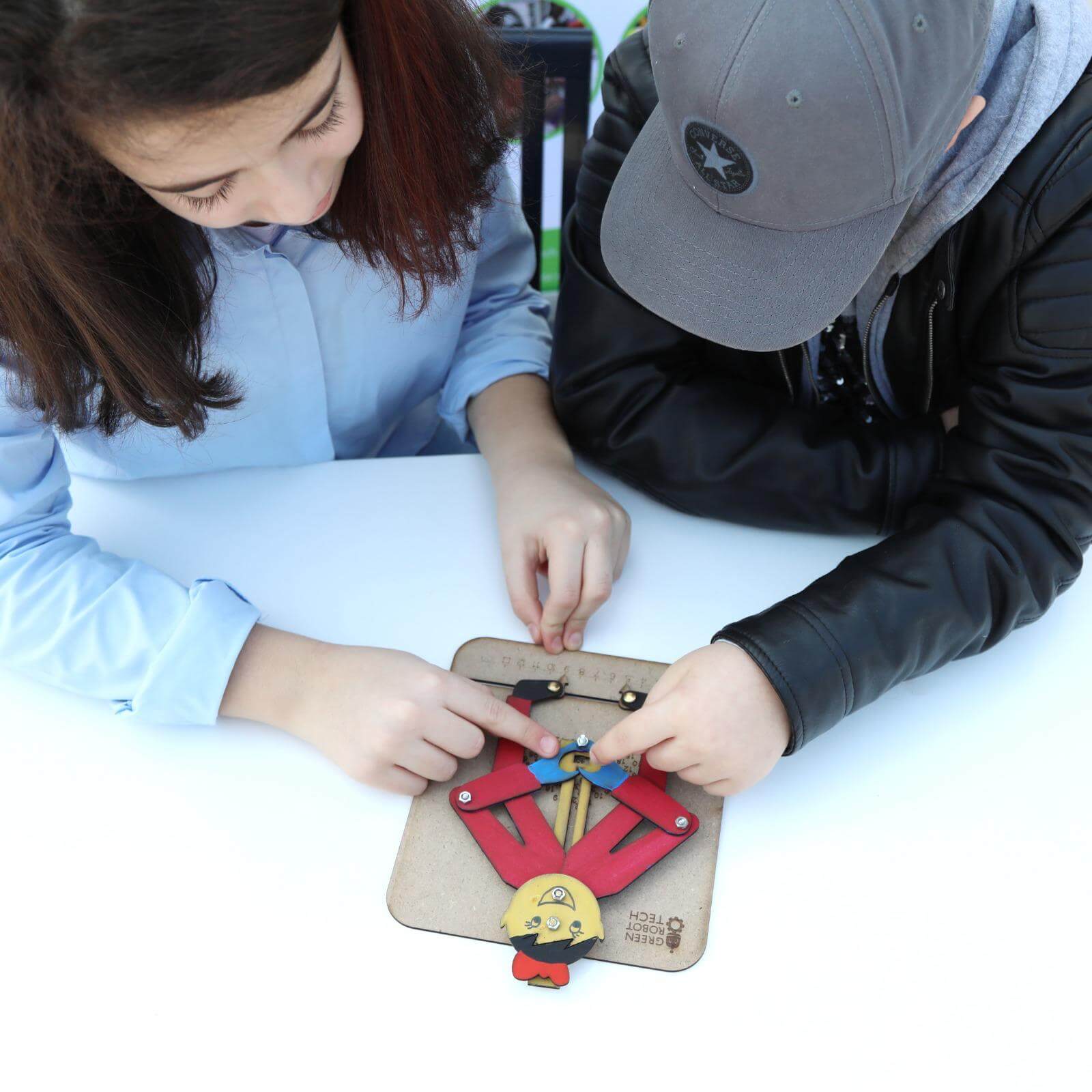 Group of children working on Green Robot Tech's hands-on learning kits