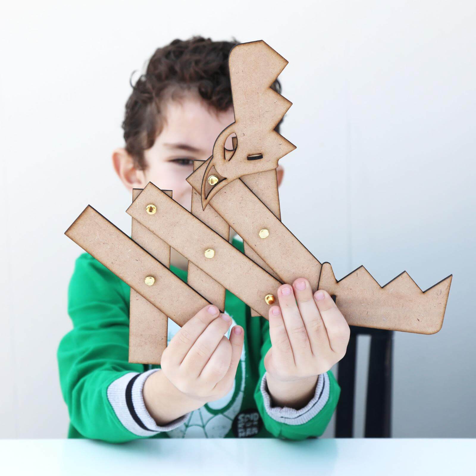 A boy opening the mouth of his new dragon STEAM kit
