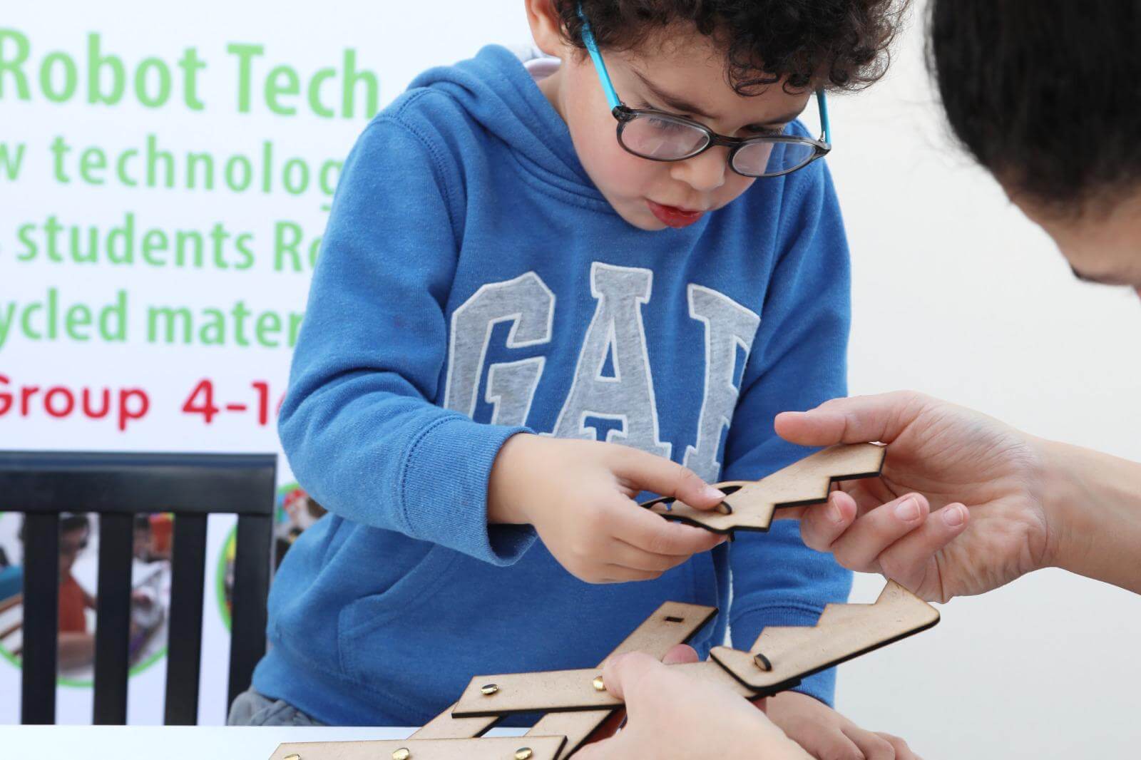 A child assembling an eco-friendly dragon model