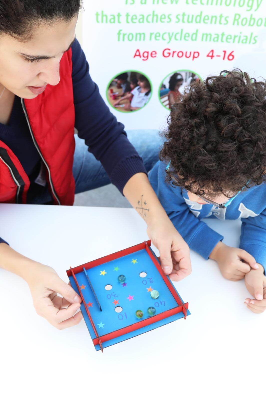 Parent and child playing with Pin Ball kit