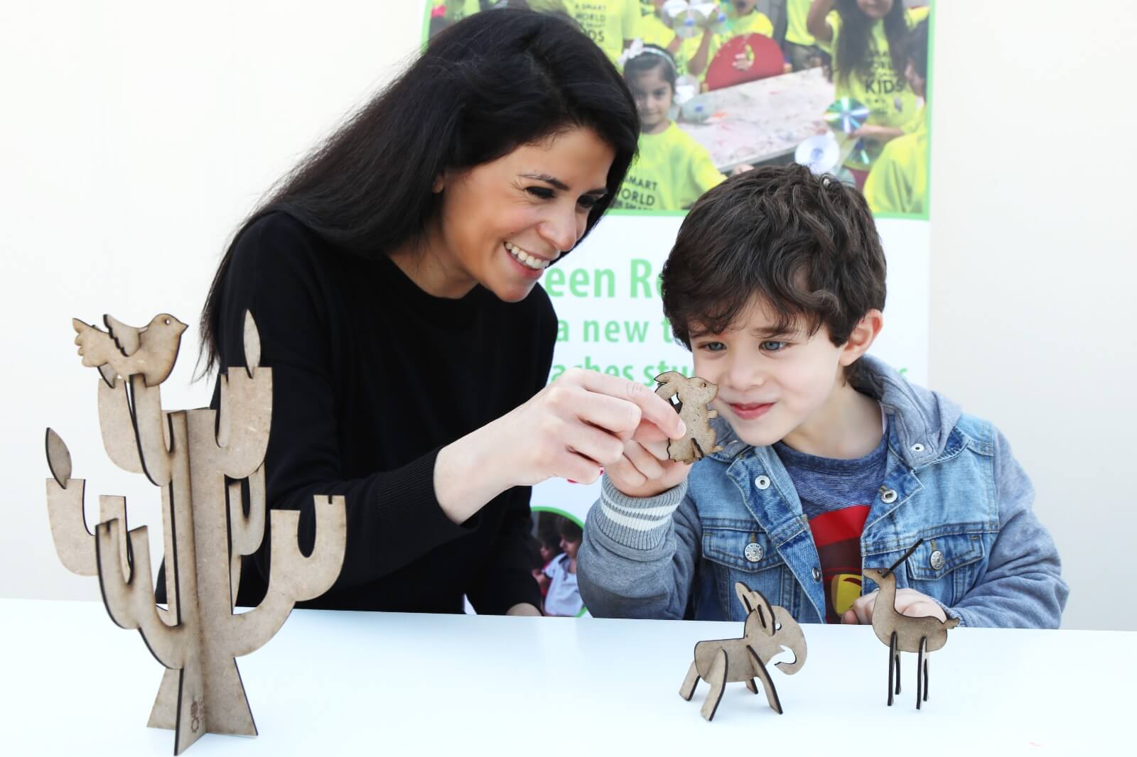 A mother and her child working on Green Robot Tech's hands-on learning kit